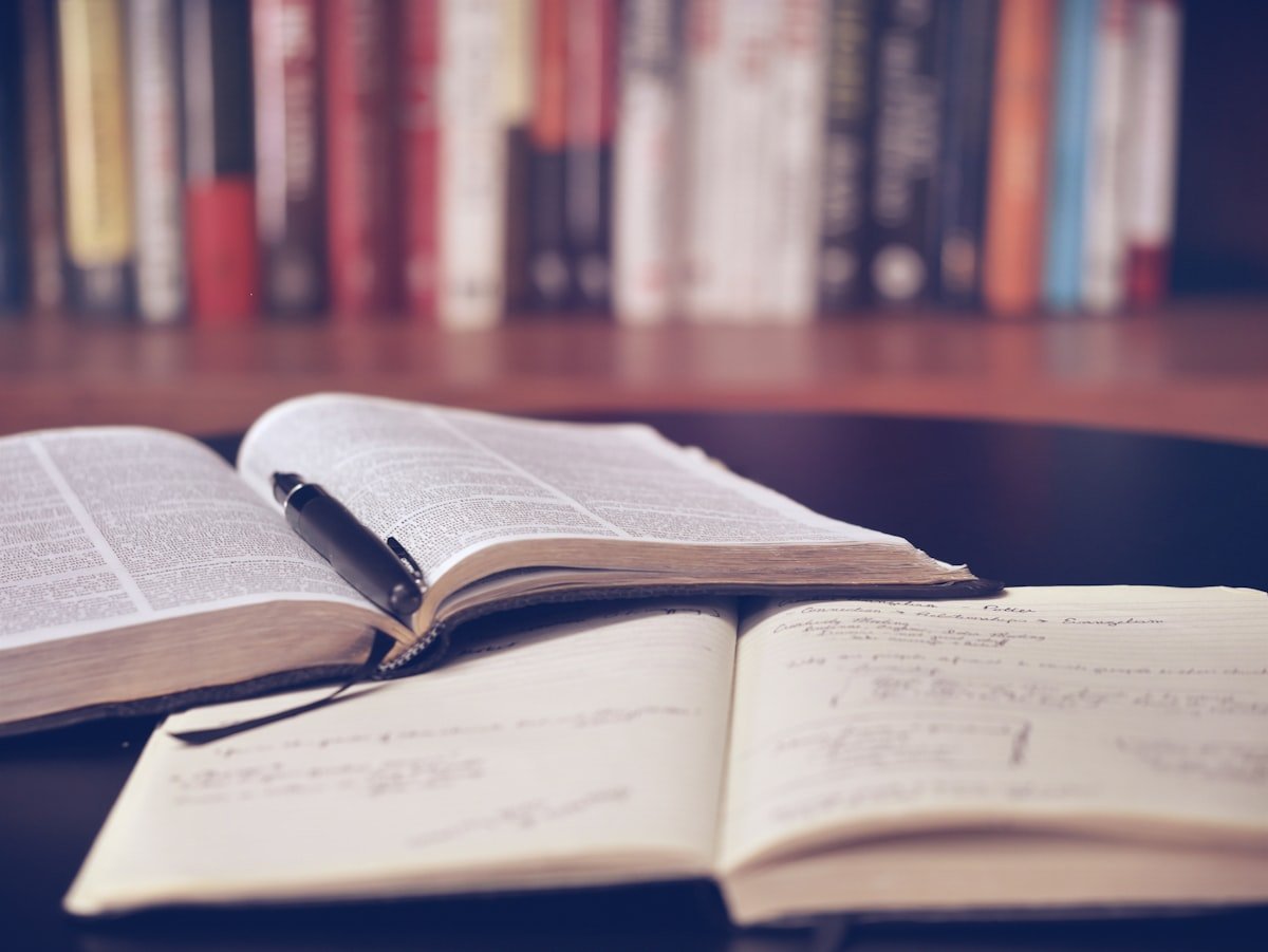 Open books and research papers on library desk