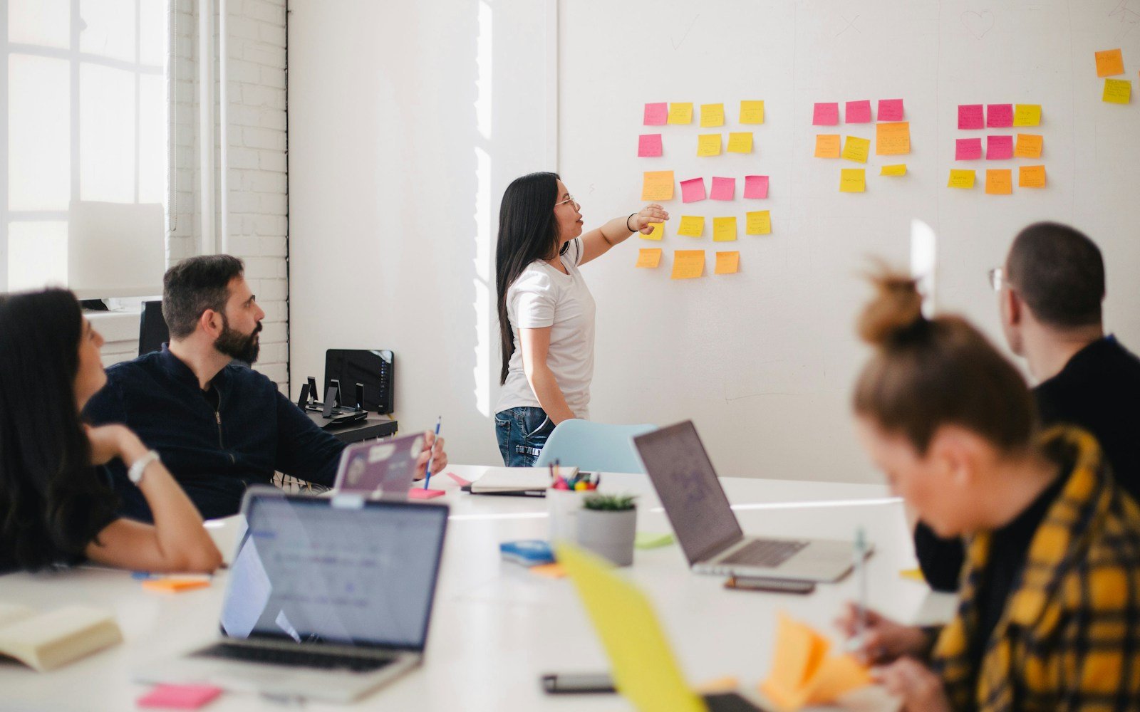 A team meeting around a whiteboard in a modern office