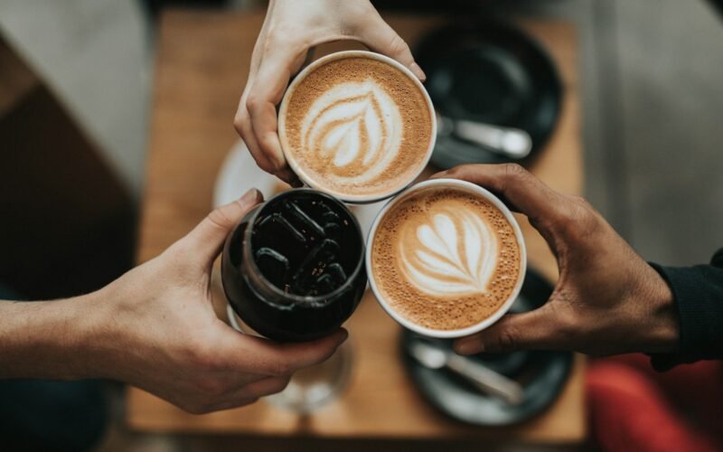 A warm cup of coffee on a wooden table in morning light