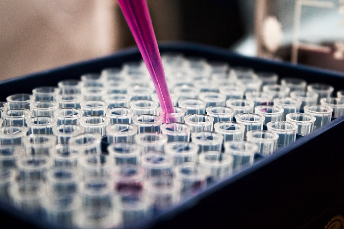 Scientist in lab coat working with molecular research equipment