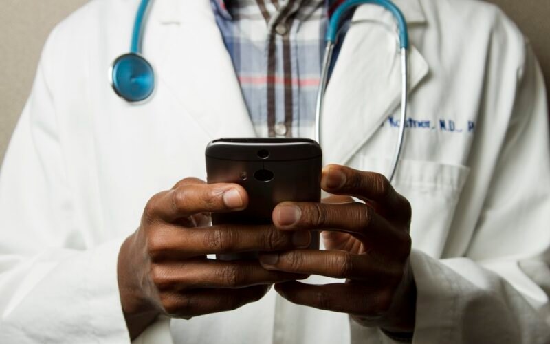 Person checking health app on smartwatch with medical data