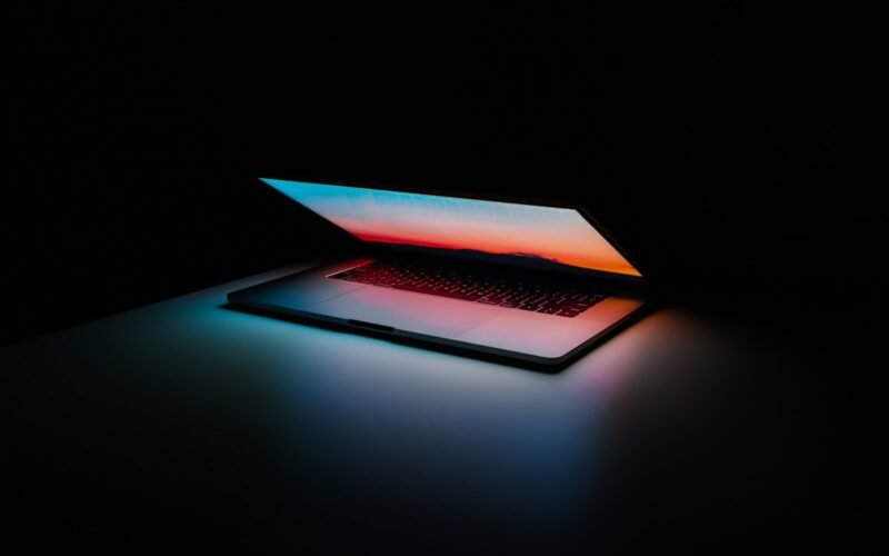 Person building a chatbot interface on laptop with flowchart