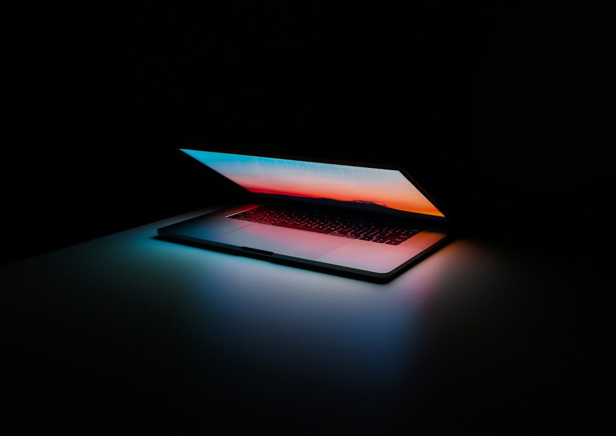 Person building a chatbot interface on laptop with flowchart