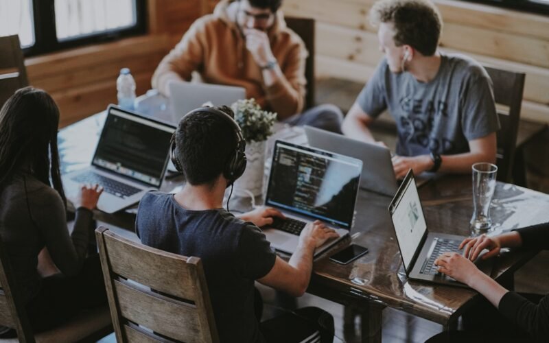 Freelancer working remotely on laptop with multiple clients